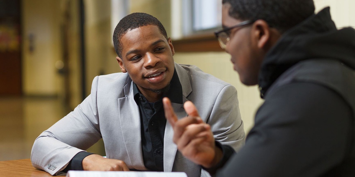 Student talking to volunteer coach